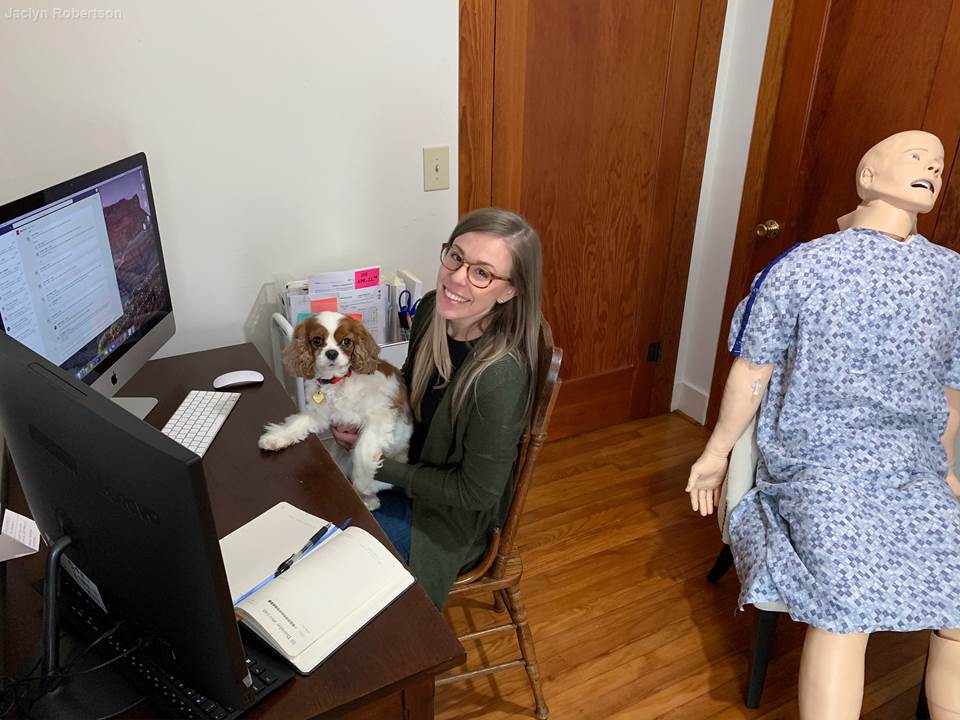 Program assistant Jaclyn Robertson and her new officemates: her dog and the medical simulation mannequin her husband had to bring home from work.